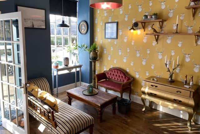 The cafe's decor includes quirky wallpaper and antique furniture and was designed by owners Gary and Nick Passey