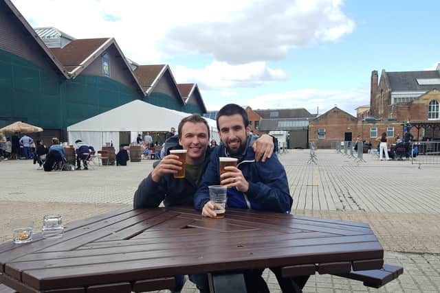 Joe Afif, right, and Callum MacGruer, left, enjoy a drink at the Corn Exchange beer garden in Edinburgh.