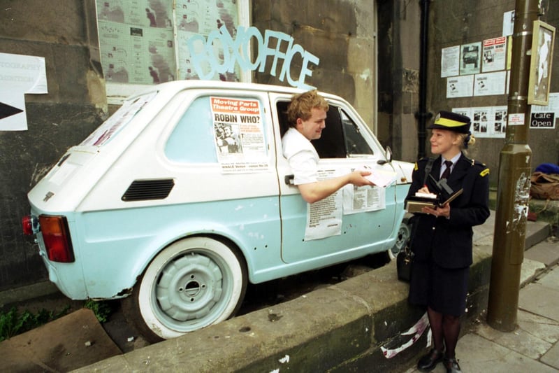 Traffic warden Audrey Banks threatens to book WHALE theatre's ticket office (half a car attached to their Broughton Street venue) during Edinburgh Festival 1993.