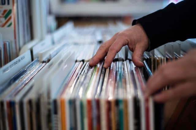 A man looks at vinyl record albums  in a music store
