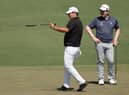Patrick Reed, the 2018 winner, offers some advice to Bob MacIntyre on the second green during a Masters practice round on Monday at Augusta National Golf Club. Picture: Kevin C. Cox/Getty Images.