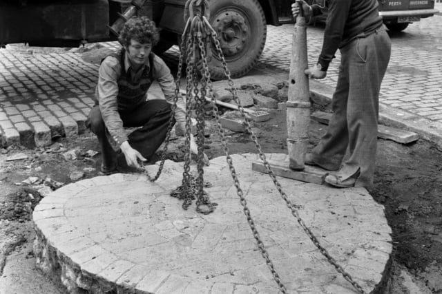 Edinburgh's 'Heart of Midlothian' stone was removed and then replaced when Parliament Square was being levelled in May 1978. Picture from left are Graham Mackie, Crane operator Michael Wereshchuk and John Richards.