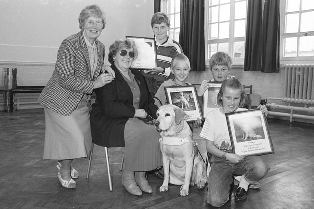 Hetton Lyons Primary School gave a boost to the Guide Dogs for the Blind Association in 1990. Pictured at the school were , left to right: Margaret Allison, chairperson of the Sunderland South Shields Branch of the Association, Mavis Brennan with her guide dog, Edna; Phillip Duffy, 10; Stephen Curran, 10; Richard Borrowdale, 11; and Danielle Wilson, 10.