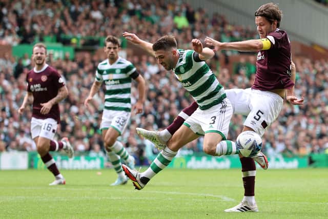 Peter Haring races back to cover his defenders and stop Celtic's Greg Taylor as he charges into the box. Picture: Steve Welsh/PA