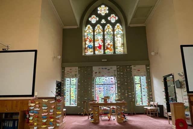 East Lothian Minister hangs paper boat in memory of daughter in church art installation.