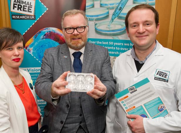 Martyn Day is pictured holding an example of a 3D organ on a chip, a cutting edge new approach method used in medical research. He is pictured next to CEO of Animal Free Research UK Carla Owen (left) and Queen Mary University London cancer research scientist, Dr Adrian Biddle. (Photo Credit AFRUK/Andrew Parsons).