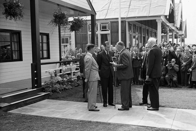 The Duke of Edinburgh receives a shepherds crook during his visit to the Royal Highland Show held in Edinburgh in 1955.