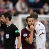 Referee Kevin Clancy shows Hearts midfielder Jorge Grant a red card against Motherwell.
