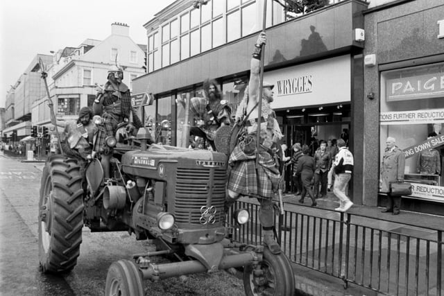 Jesse Rae (middle) and The Clansmen arrive by tractor to open the new Wrygges fashion store in Princes Street Edinburgh, November 1987.