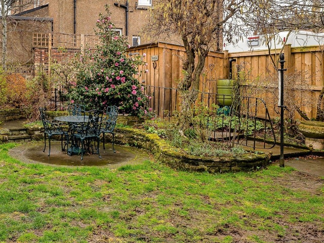 This fully powered shed is tucked away neatly in the corner of the garden.