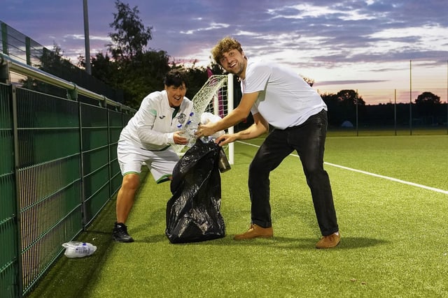 Hibs staff clear up the training ground after the football marathon comes to an end at East Mains.