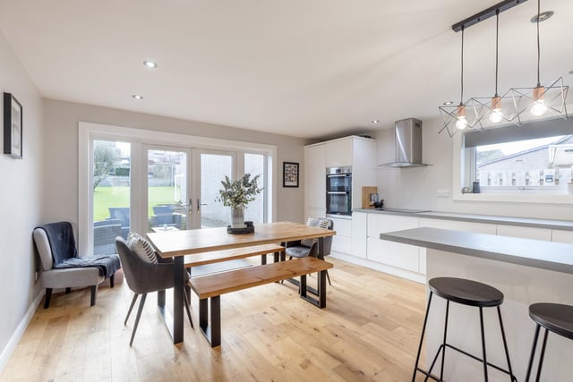 The modern fitted dining kitchen comes with wall and base units, integrated appliances and patio doors to the enclosed rear garden and decking/patio areas.