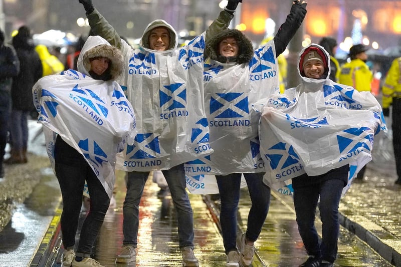 These four revellers on Princes Street kept dry with their ponchos. Picture: Andrew Milligan/PA Wire