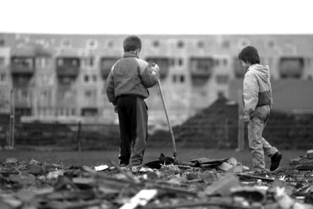 Two little boys playing in the rubble left after the old flats at West Granton were demolished, December 1992.