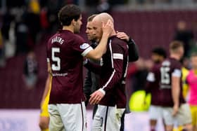 Hearts midfielder Peter Haring and manager Robbie Neilson console Liam Boyce at full time on Saturday.