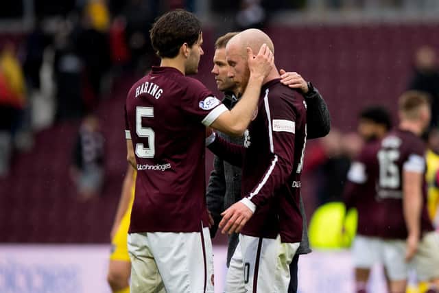 Hearts midfielder Peter Haring and manager Robbie Neilson console Liam Boyce at full time on Saturday.