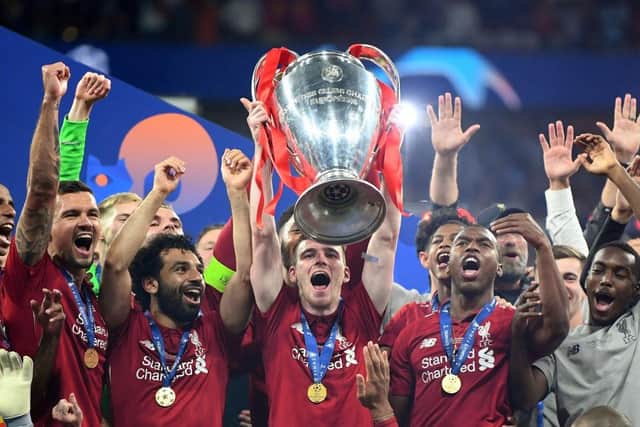 Andy Robertson of Liverpool lifts the Champions League Trophy after winning the UEFA Champions League Final between Tottenham Hotspur and Liverpool at Estadio Wanda Metropolitano on June 01, 2019 in Madrid, Spain. (Photo by Michael Regan/Getty Images)