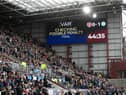 The big screen lets fans know about the VAR check for the penalty awarded to Hearts just before half time. Picture: Craig Williamson / SNS