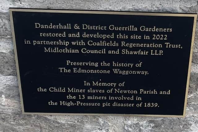 The plaque on the statue.