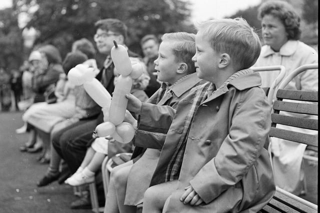 Princes Street Gardens Punch and Judy show - twin boys with balloon animals watching the performance at the Ross bandstand in 1963.