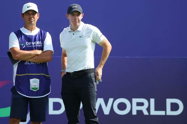 Rory McIlroy talks to caddie Harry Diamond before teeing off on day one of the DP World Tour Championship. Andrew Redington/Getty Images.