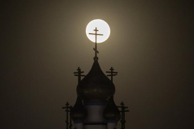 A supermoon rises behind the Holy Transfiguration Russian Orthodox Cathedral in Los Angeles, Tuesday, June 14, 2022. It is also referred to as the Strawberry Moon because it is the full moon at strawberry harvest time.