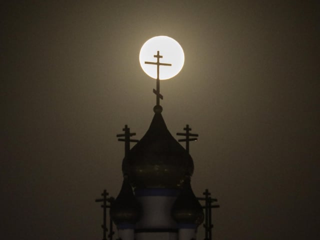 A supermoon rises behind the Holy Transfiguration Russian Orthodox Cathedral in Los Angeles, Tuesday, June 14, 2022. It is also referred to as the Strawberry Moon because it is the full moon at strawberry harvest time.