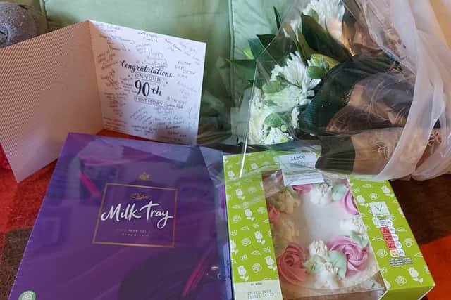 Tesco delivery drivers surprised the elderly woman with a box of gifts on her birthday including flowers, a cake and a gift voucher picture: supplied