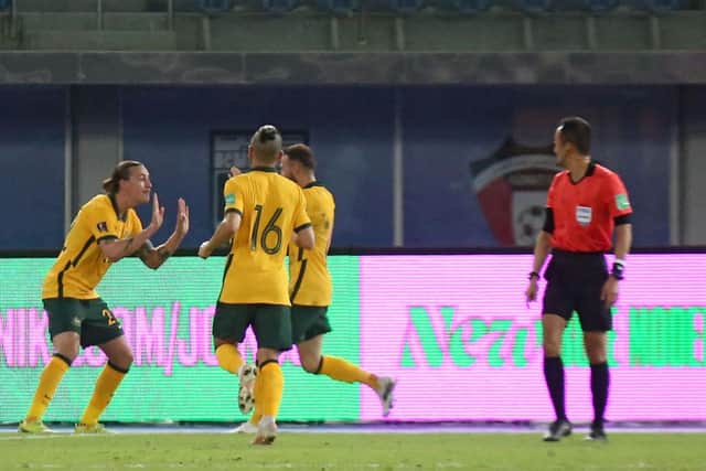 Australia's midfielder Jackson Irvine (L) celebrates after scoring the second goal during the 2022 FIFA World Cup qualification group B football match between Australia and Kuwait.  (Photo by YASSER AL-ZAYYAT/AFP via Getty Images)