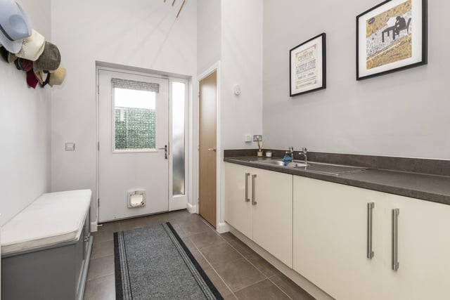 On the ground floor is an inviting hall which leads to a bedroom, currently used as a study, a utility room and a WC compartment and a door gives direct access to the larger than average integral garage.