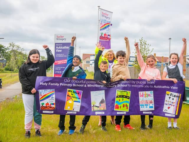 The winner from Holy Family Primary (second from left) with his winning flag design, alongside Taylor Wimpey East Scotland’s sales executive Amanda Baxter and the runners-up from both Holy Family and Winchburgh Primary schools.