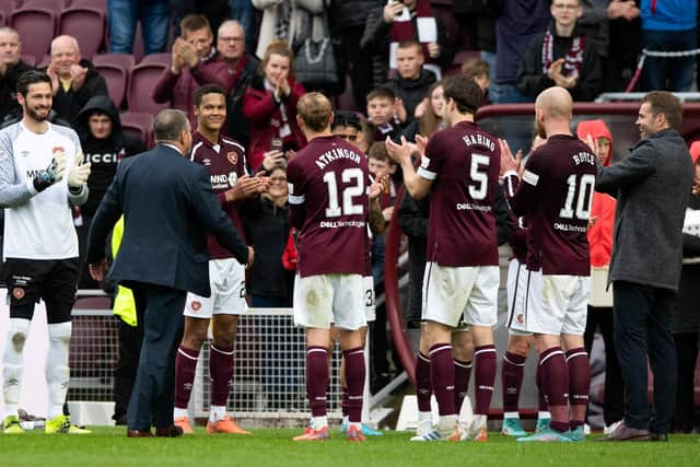 The Hearts players and head coach Robbie Neilson applaud Scott Wilson off the pitch at full-time in his final match as stadium announcer at Tynecastle Park. Picture: SNS