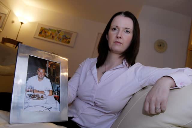 Louise Adamson with a picture of her brother Michael, who was electrocuted in an accident at work    Photograph: Kenny Smith
