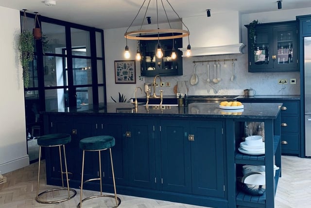The small, dark kitchen was given a significant extension, with a stylish granite island in the middle complete with a set of plush bar stools.
