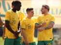 Thomas Deng, Cammy Devlin and Jason Cummings pose for Australia's official team photo in Doha before their opener against France. Picture: Robert Cianflone/Getty
