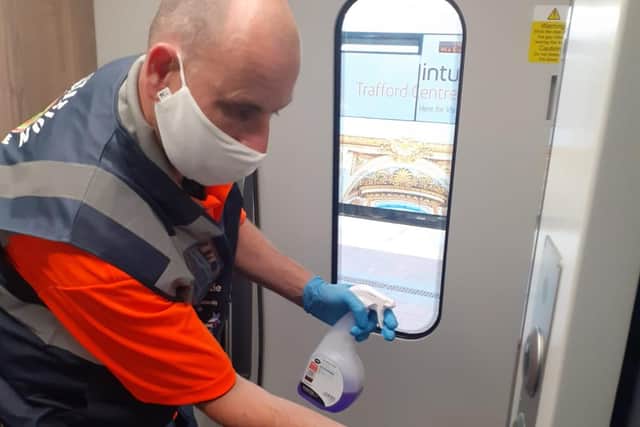 A member of the sanitisation team out of their elf costume and hard at work cleaning the trains for customer safety across Edinburgh (photo: TPE).