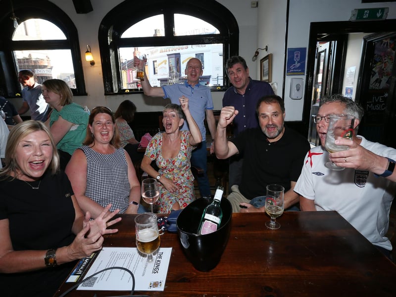From left, Jane Nockemann, Sarah Mann, Helen Pescott, Dave Keeble, Rich Pescott, Rob Nockemann and Andy Mann. Fans watch England v Ukraine in the quarter finals of Euro 2020, in The Kings pub, Albert Rd, Southsea. Picture: Chris Moorhouse (jpns 030721-17)