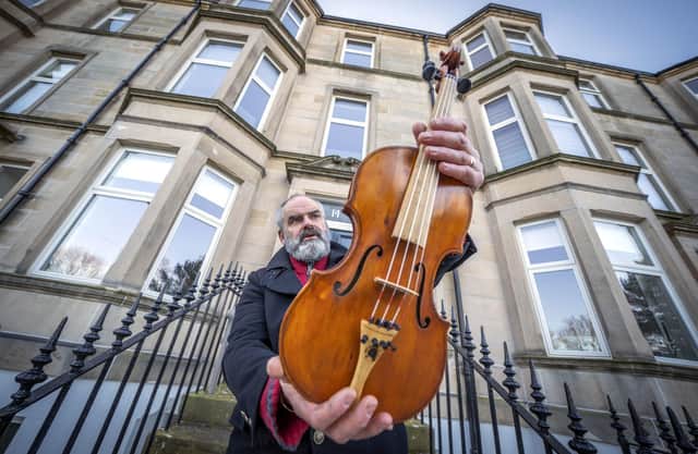 Edinburgh based luthier and nature conservationist Steve Burnett holds the Ernest Shackleton Driftwood Violin