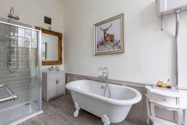 The stylish and recently fitted en-suite bathroom features a free-standing bath as well as a separate shower unit.
