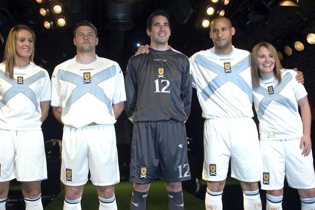 Graeme Murty, Neil Alexander and Nigel Quashie are flanked by Julie Fleeting and Jo Love to launch a new white away kit in March 2007 dominated by a baby blue saltire across the chest