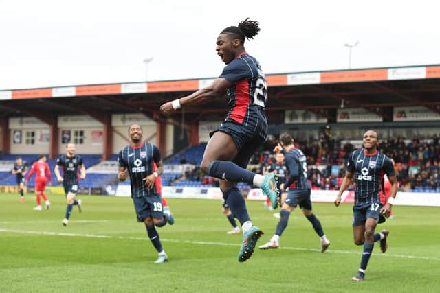 Joseph Hungbo celebrates after scoring for Ross County as Regan Charles-Cook and others arrive.