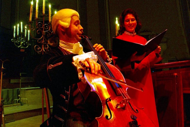 Celloist Simon Turner of the Mozart Festival Orchestra and Alto Singer Laura Malcolm of the Consort of Voices duet together on stage after performing with their orchestra at the Usher Hall, Edinburgh; December 19, 2002. The Consort of Voices and the Mozart Festival Orchestra together performed their "Carols by Candlelight" a selection of choral favourites and Christmas Carols.