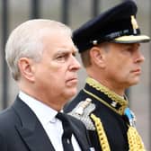 Prince Andrew, Duke of York (L) and Britain's Prince Edward, Earl of Wessex (R) follow a Bearer Party of The Queen's Company, 1st Battalion Grenadier Guards carrying the coffin of Queen Elizabeth II outside Westminster Abbey. (Photo by HANNAH MCKAY / POOL / AFP) (Photo by HANNAH MCKAY/POOL/AFP via Getty Images)