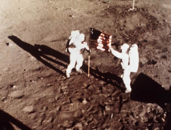 On July 20, 1969 Apollo 11 astronauts Neil Armstrong and Edwin E. 'Buzz' Aldrin, the first men to land on the moon, plant the US flag on the lunar surface