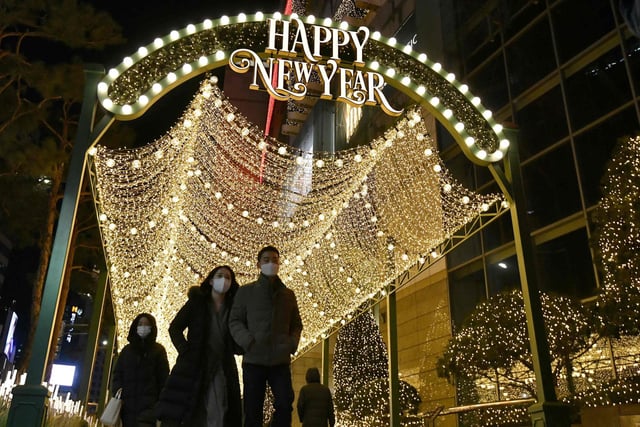 People visit a shopping district on New Year's Eve in Seoul on December 31, 2020.