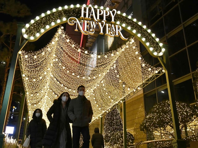 People visit a shopping district on New Year's Eve in Seoul on December 31, 2020.