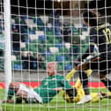 Hearts forward Liam Boyce puts the ball over the line for the opening goal of the UEFA Nations League Group B1 match between Northern Ireland and Romania at Windsor Park. (Photo by PAUL FAITH / AFP)