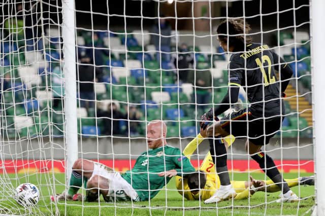 Hearts forward Liam Boyce puts the ball over the line for the opening goal of the UEFA Nations League Group B1 match between Northern Ireland and Romania at Windsor Park. (Photo by PAUL FAITH / AFP)