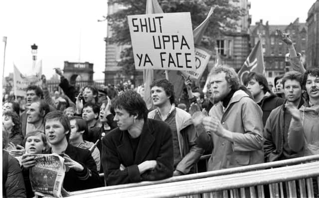 Protestors shout at Prime Minister Margaret Thatcher when she arrives in Edinburgh to open the General Assembly of the Church of Scotland in May 1981.