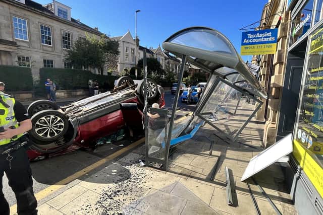 After the crash in Edinburgh's Inverleith Row, the car landed on its roof, demolishing the bus stop.  Picture: Ian McAteer.